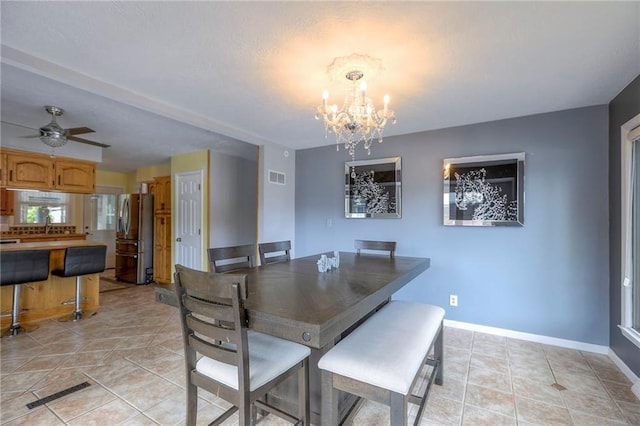 2508 N Mcbride Ave, Sugar Creek, MO 64050 - dining room featuring a chandelier, light tile patterned flooring, and a ceiling fan