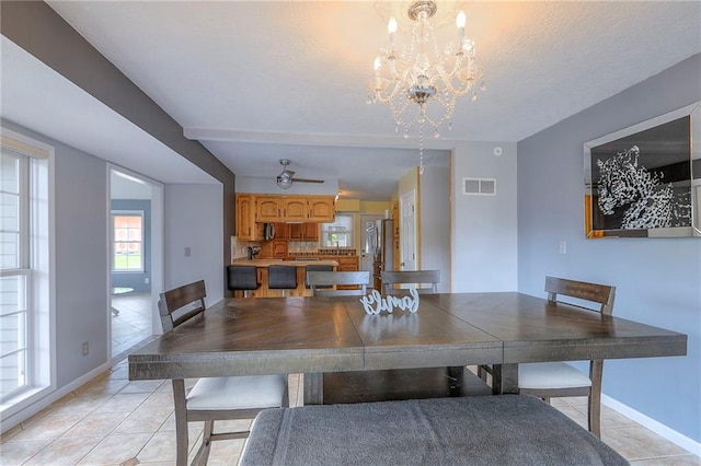 2508 N Mcbride Ave, Sugar Creek, MO 64050 - dining area with light tile patterned flooring and a chandelier