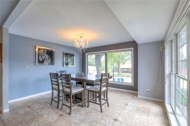 2508 N Mcbride Ave, Sugar Creek, MO 64050 - dining space with a chandelier, plenty of natural light, light tile patterned floors, and a textured ceiling