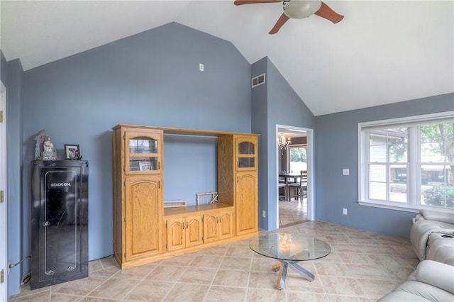 2508 N Mcbride Ave, Sugar Creek, MO 64050 - living area featuring a ceiling fan, healthy amount of natural light, high vaulted ceiling, and light tile patterned floors