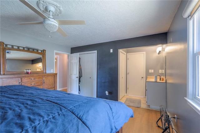2508 N Mcbride Ave, Sugar Creek, MO 64050 - bedroom with wood finished floors, a textured ceiling, and a ceiling fan
