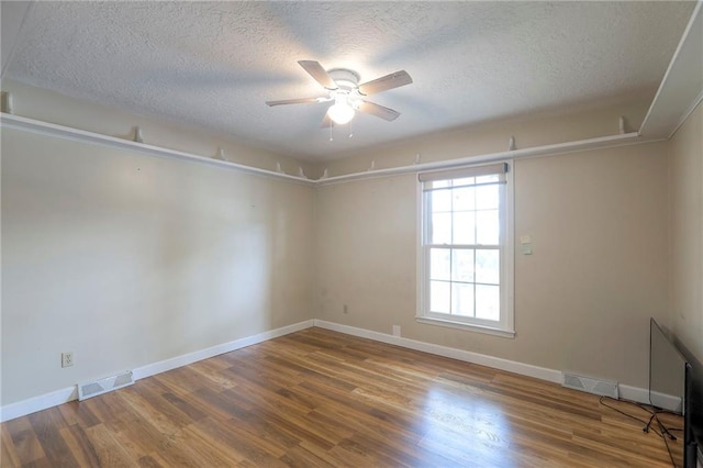 2508 N Mcbride Ave, Sugar Creek, MO 64050 - unfurnished room featuring a textured ceiling, wood finished floors, and ceiling fan