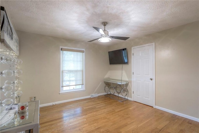 2508 N Mcbride Ave, Sugar Creek, MO 64050 - bonus room featuring light wood-type flooring, ceiling fan, and a textured ceiling