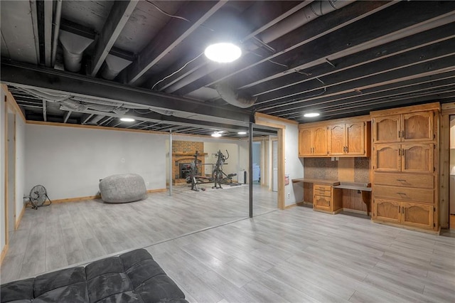2508 N Mcbride Ave, Sugar Creek, MO 64050 - finished basement with a desk and light wood-style flooring