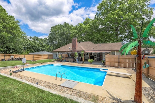 2508 N Mcbride Ave, Sugar Creek, MO 64050 - view of swimming pool with a patio, a fenced backyard, and a diving board