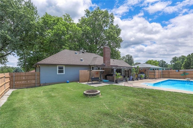 2508 N Mcbride Ave, Sugar Creek, MO 64050 - back of house with a fire pit, a fenced backyard, a chimney, and a patio