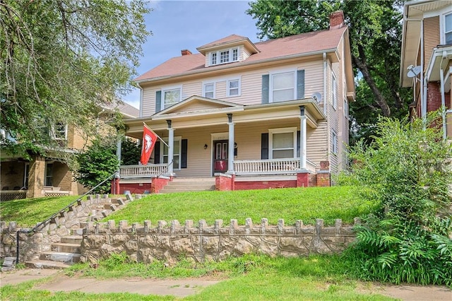 2517 Felix St, Saint Joseph, MO 64501 - american foursquare style home with a porch, a chimney, stairway, and a front yard