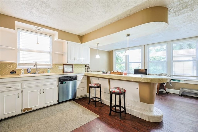 2517 Felix St, Saint Joseph, MO 64501 - kitchen featuring stainless steel dishwasher, open shelves, a peninsula, dark wood finished floors, and white cabinets