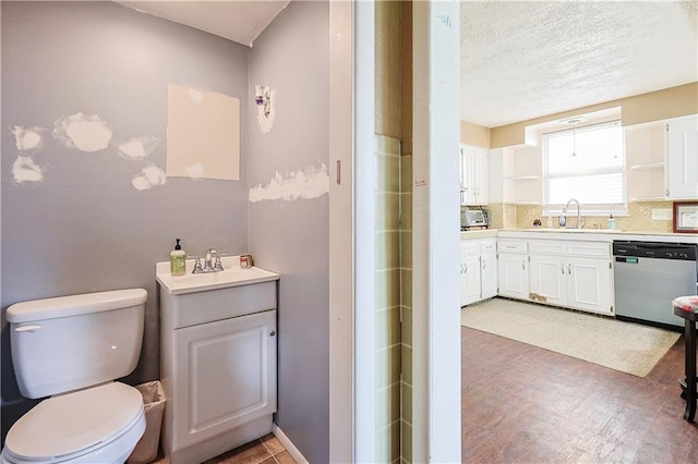 2517 Felix St, Saint Joseph, MO 64501 - full bath with vanity, backsplash, a textured ceiling, and wood finished floors