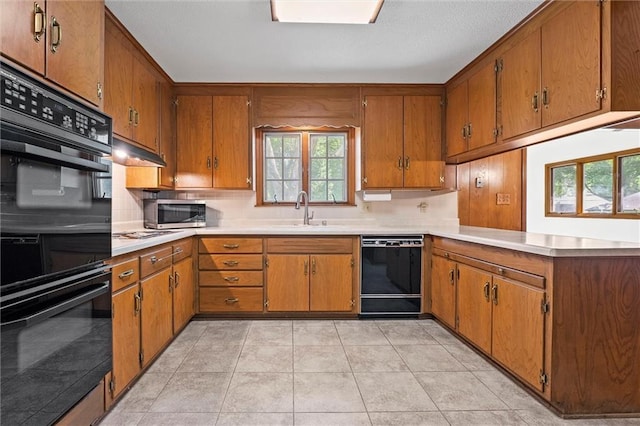 3300 W 93rd St, Leawood, KS 66206 - kitchen featuring black appliances, brown cabinets, light countertops, and a peninsula