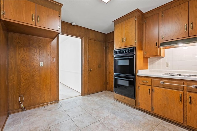 3300 W 93rd St, Leawood, KS 66206 - kitchen with brown cabinetry, decorative backsplash, light countertops, and light tile patterned floors