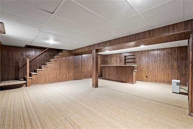 3300 W 93rd St, Leawood, KS 66206 - finished below grade area featuring carpet floors, wooden walls, stairway, a bar, and a paneled ceiling