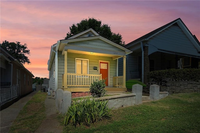 422 N Thompson St, Kansas City, KS 66101 - view of front facade featuring covered porch and a front lawn