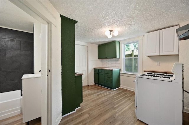 422 N Thompson St, Kansas City, KS 66101 - kitchen featuring green cabinetry, gas range gas stove, light wood-type flooring, a textured ceiling, and white cabinetry