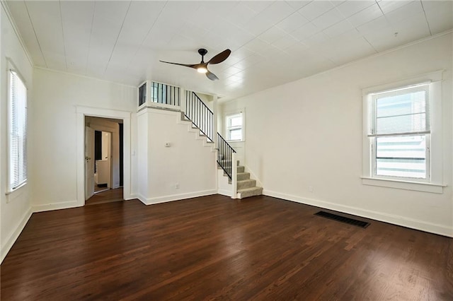 422 N Thompson St, Kansas City, KS 66101 - empty room with stairs, dark wood-style floors, a ceiling fan, and crown molding