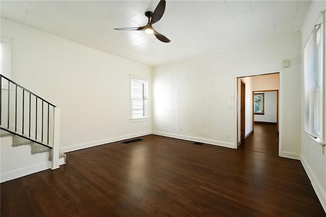 422 N Thompson St, Kansas City, KS 66101 - empty room with ceiling fan, wood finished floors, and stairway