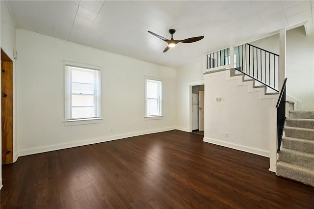 422 N Thompson St, Kansas City, KS 66101 - unfurnished living room featuring ceiling fan, stairs, healthy amount of natural light, and crown molding