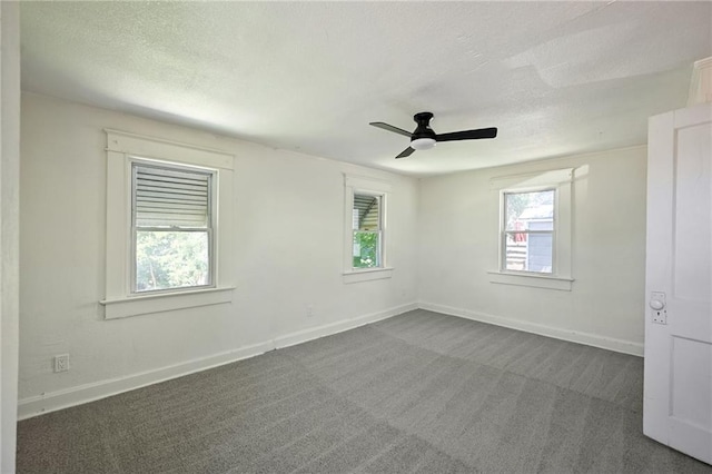 422 N Thompson St, Kansas City, KS 66101 - spare room featuring dark carpet, ceiling fan, and a textured ceiling