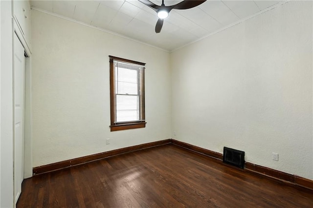 422 N Thompson St, Kansas City, KS 66101 - unfurnished room with crown molding, ceiling fan, and dark wood-type flooring