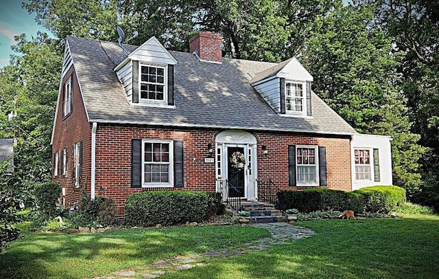 2003 S Elm St, Pittsburg, KS 66762 - cape cod-style house with brick siding, a chimney, a front yard, and roof with shingles