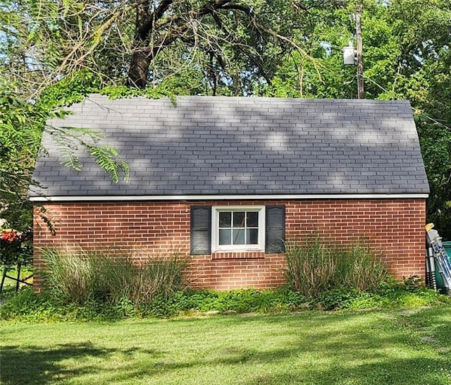 2003 S Elm St, Pittsburg, KS 66762 - view of property exterior with a yard, brick siding, and a shingled roof