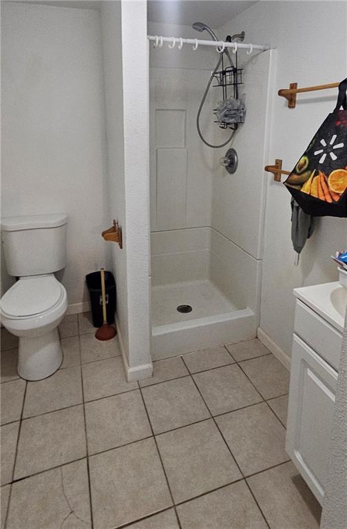 2003 S Elm St, Pittsburg, KS 66762 - bathroom featuring tile patterned flooring, a shower stall, and vanity