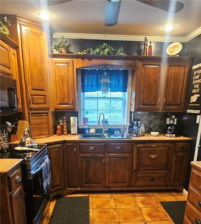 2003 S Elm St, Pittsburg, KS 66762 - kitchen with range with electric cooktop, black microwave, decorative backsplash, ornamental molding, and light countertops