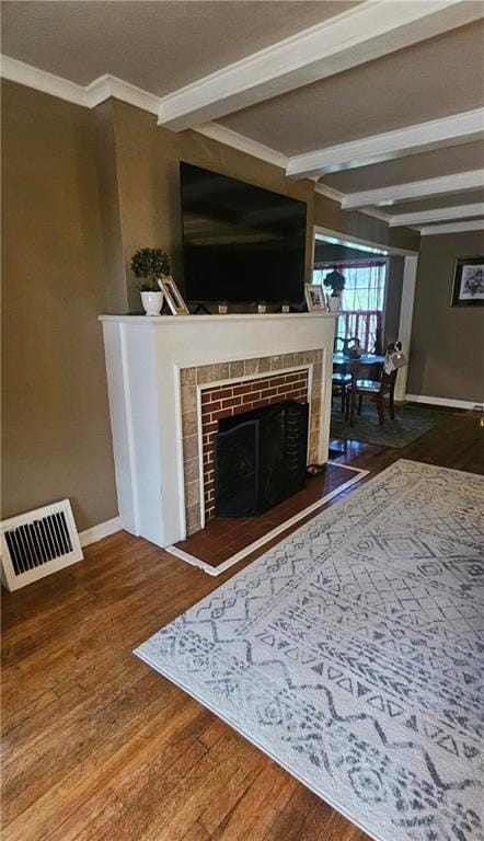 2003 S Elm St, Pittsburg, KS 66762 - living room featuring wood finished floors, a fireplace, beam ceiling, and crown molding