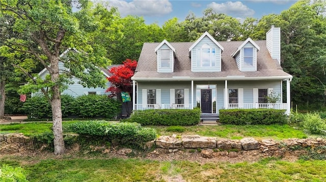 731 E 1100th Rd, Baldwin City, KS 66006 - cape cod house featuring a chimney and a porch