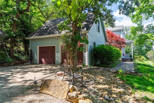 731 E 1100th Rd, Baldwin City, KS 66006 - view of home's exterior with a garage and concrete driveway