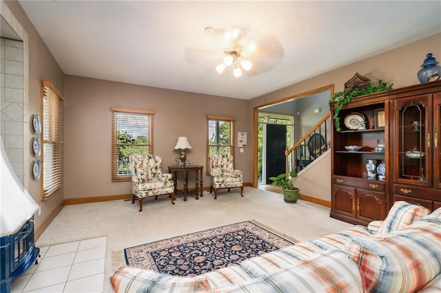 731 E 1100th Rd, Baldwin City, KS 66006 - living area with a ceiling fan, light carpet, stairway, and plenty of natural light