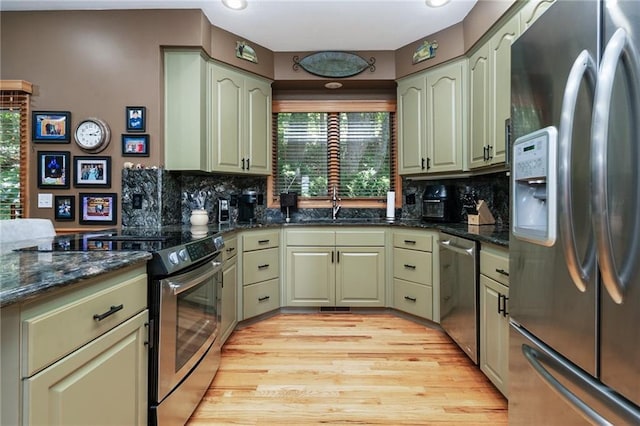 731 E 1100th Rd, Baldwin City, KS 66006 - kitchen featuring appliances with stainless steel finishes, green cabinetry, tasteful backsplash, dark stone countertops, and recessed lighting