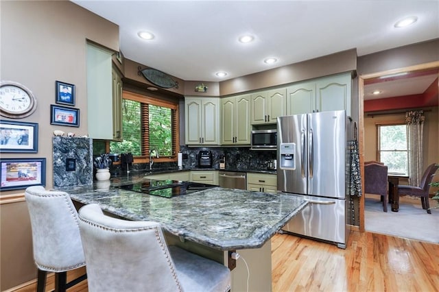 731 E 1100th Rd, Baldwin City, KS 66006 - kitchen featuring stainless steel appliances, a peninsula, healthy amount of natural light, light wood-style flooring, and recessed lighting