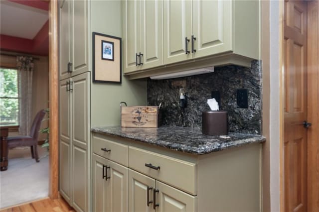 731 E 1100th Rd, Baldwin City, KS 66006 - kitchen with decorative backsplash, dark stone countertops, and light wood finished floors