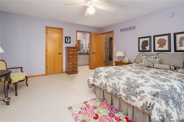 731 E 1100th Rd, Baldwin City, KS 66006 - bedroom with light colored carpet, ceiling fan, and connected bathroom