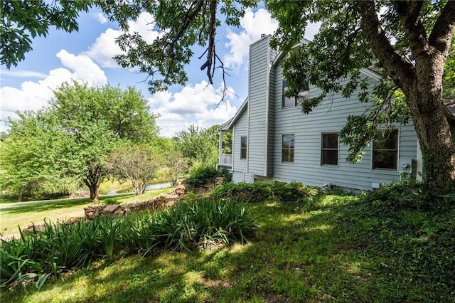 731 E 1100th Rd, Baldwin City, KS 66006 - view of home's exterior featuring a chimney and a yard