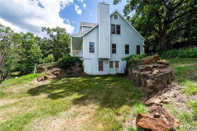 731 E 1100th Rd, Baldwin City, KS 66006 - rear view of house featuring a lawn and a chimney