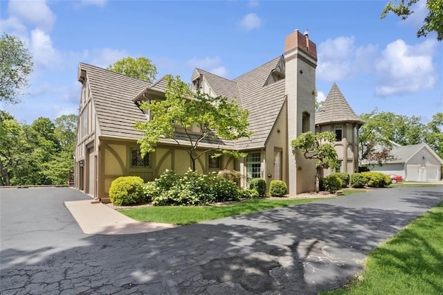 8320 Maplewood Ln, Lenexa, KS 66215 - view of front of property featuring a chimney, stucco siding, and asphalt driveway