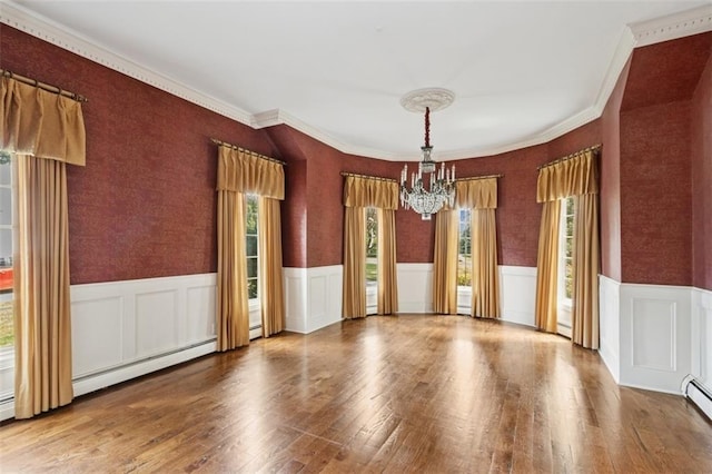 8320 Maplewood Ln, Lenexa, KS 66215 - unfurnished dining area featuring a chandelier, a wainscoted wall, wood finished floors, crown molding, and wallpapered walls