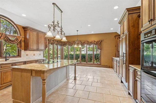 8320 Maplewood Ln, Lenexa, KS 66215 - kitchen with healthy amount of natural light, recessed lighting, black appliances, and brown cabinets