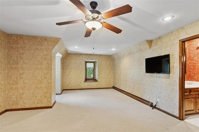 8320 Maplewood Ln, Lenexa, KS 66215 - empty room with light colored carpet, a ceiling fan, wallpapered walls, and recessed lighting