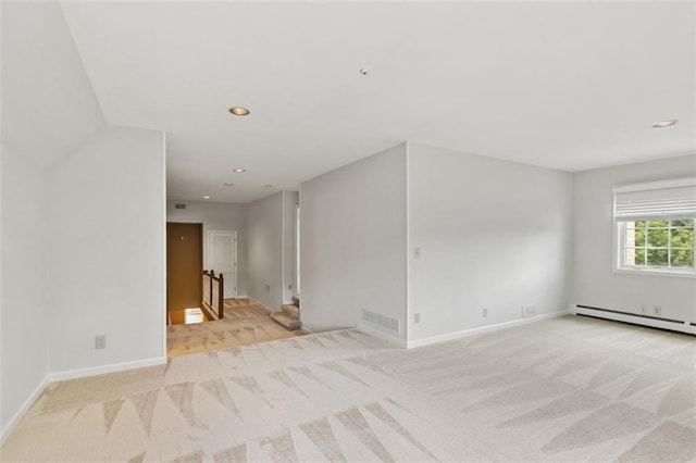 8320 Maplewood Ln, Lenexa, KS 66215 - empty room featuring a baseboard radiator, light colored carpet, and recessed lighting