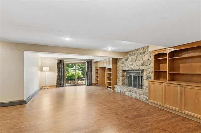 8320 Maplewood Ln, Lenexa, KS 66215 - unfurnished living room featuring wood finished floors and a fireplace