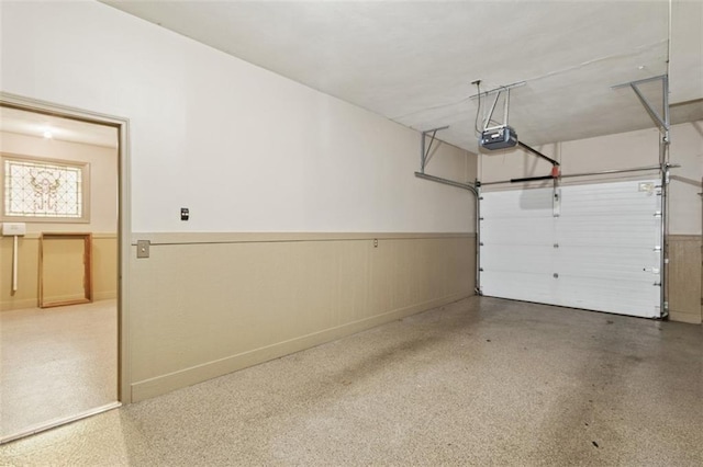 8320 Maplewood Ln, Lenexa, KS 66215 - garage featuring a wainscoted wall and a garage door opener