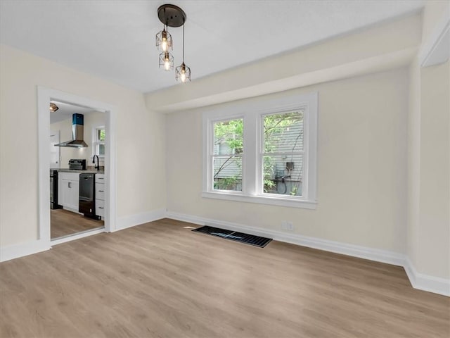 3928 E 58th St, Kansas City, MO 64132 - unfurnished dining area featuring light wood finished floors