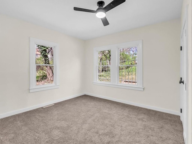 3928 E 58th St, Kansas City, MO 64132 - empty room featuring plenty of natural light, carpet flooring, and ceiling fan