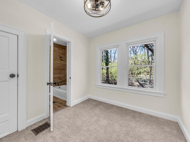 3928 E 58th St, Kansas City, MO 64132 - unfurnished bedroom with light colored carpet and ensuite bath