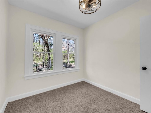 3928 E 58th St, Kansas City, MO 64132 - empty room featuring carpet flooring and a chandelier