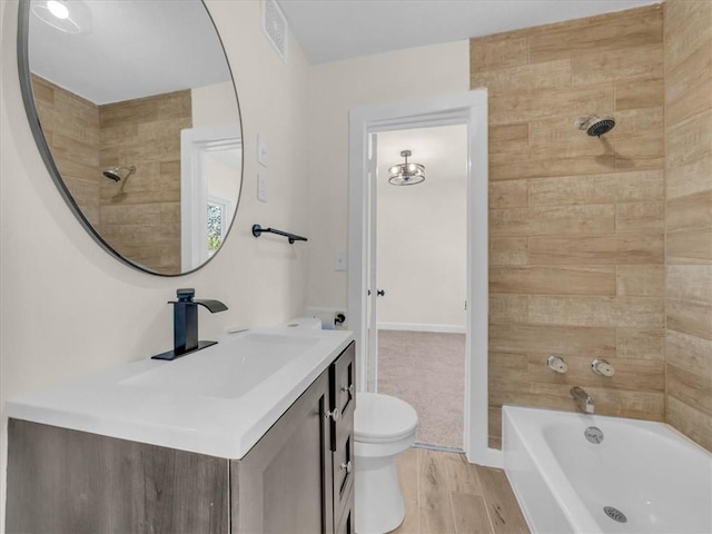 3928 E 58th St, Kansas City, MO 64132 - full bathroom with vanity, shower / bathtub combination, and wood finished floors