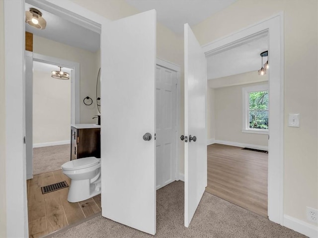 3928 E 58th St, Kansas City, MO 64132 - bathroom featuring vanity and wood finished floors